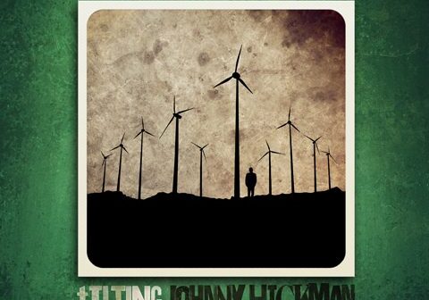 Silhouette of wind turbines and person.