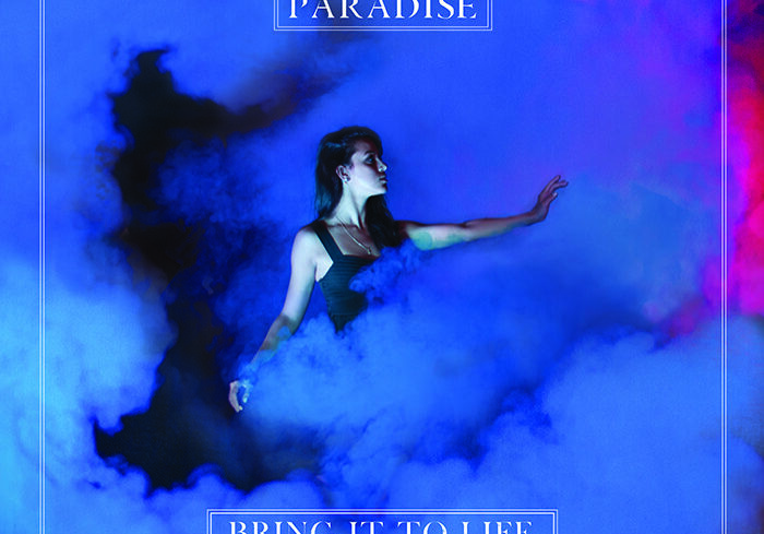 Woman in smoky blue and purple light.