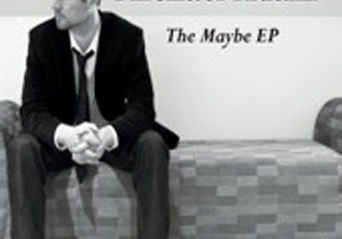 Man sitting on a sofa, album cover.