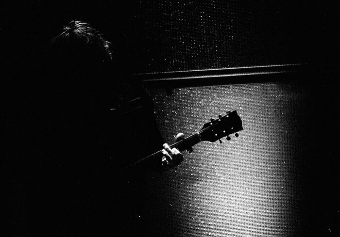 Silhouette of guitarist with electric guitar.