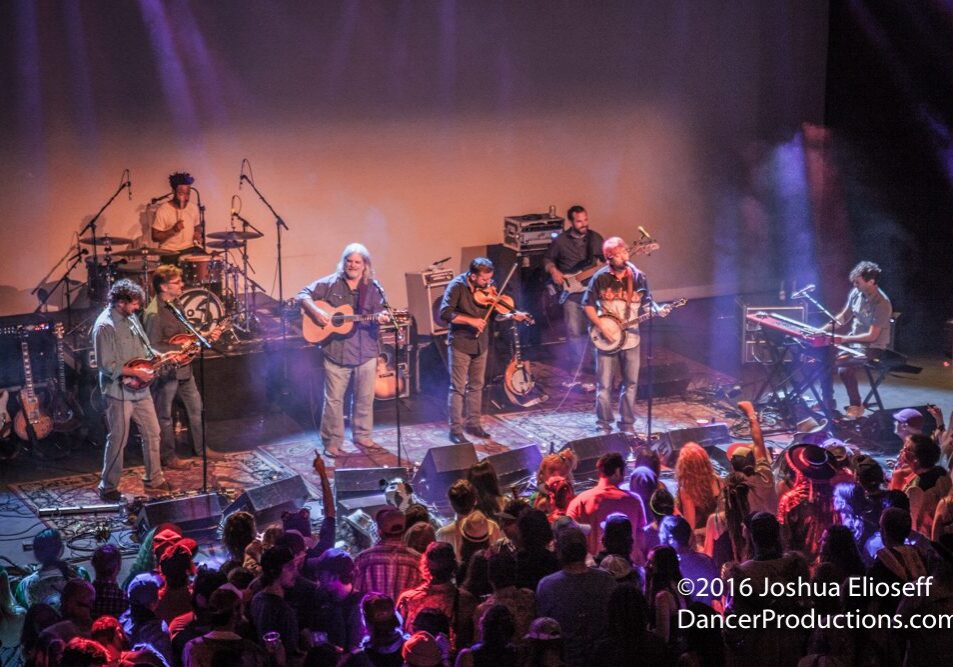 Band performing live on stage with audience.