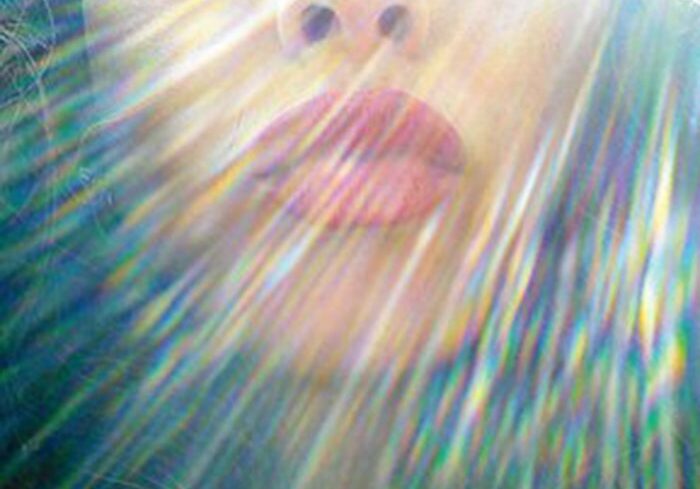 Face with colorful light rays effect.