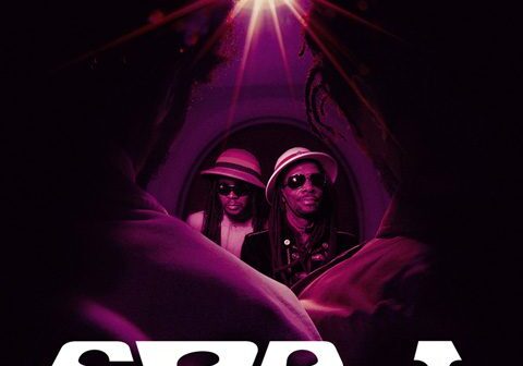 Two musicians under purple lighting, See-I text.