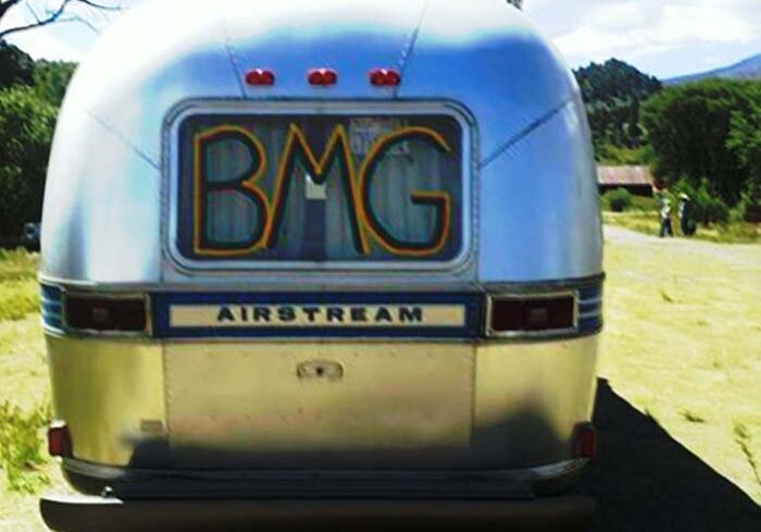 Airstream trailer with "charmed life" text.