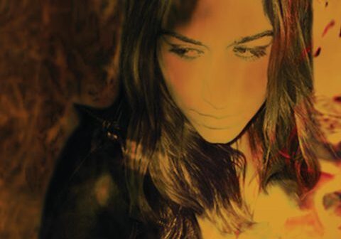 A woman with long hair, abstract lighting.