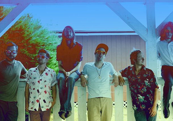 Group of people posing under a structure.