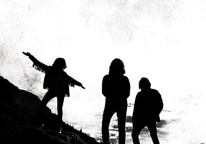 Silhouetted figures on a rocky landscape.