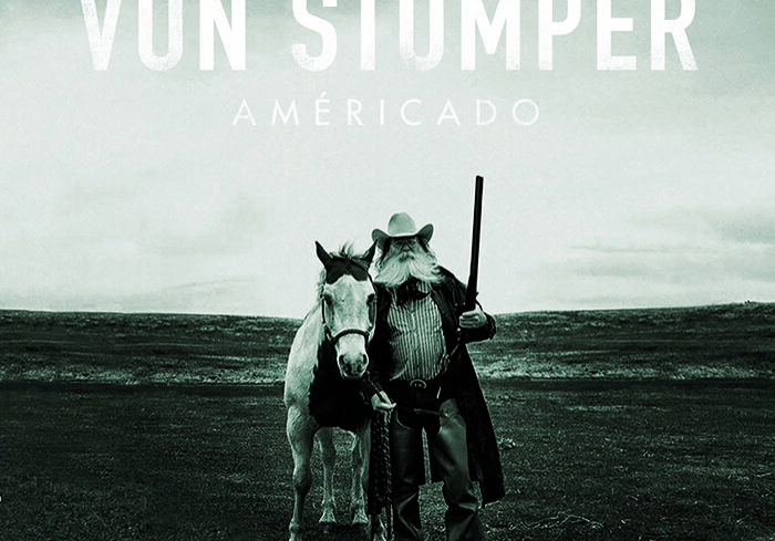 Man with horse on open landscape.