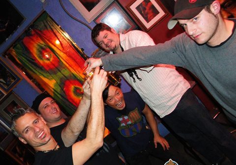 Group of friends toasting with drinks.