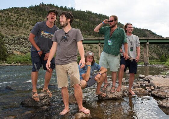 Group of friends posing by a river.