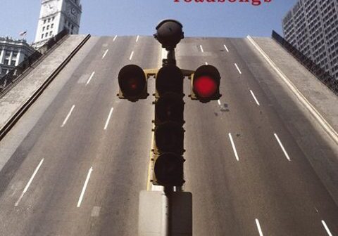Traffic light and steep road, city background.
