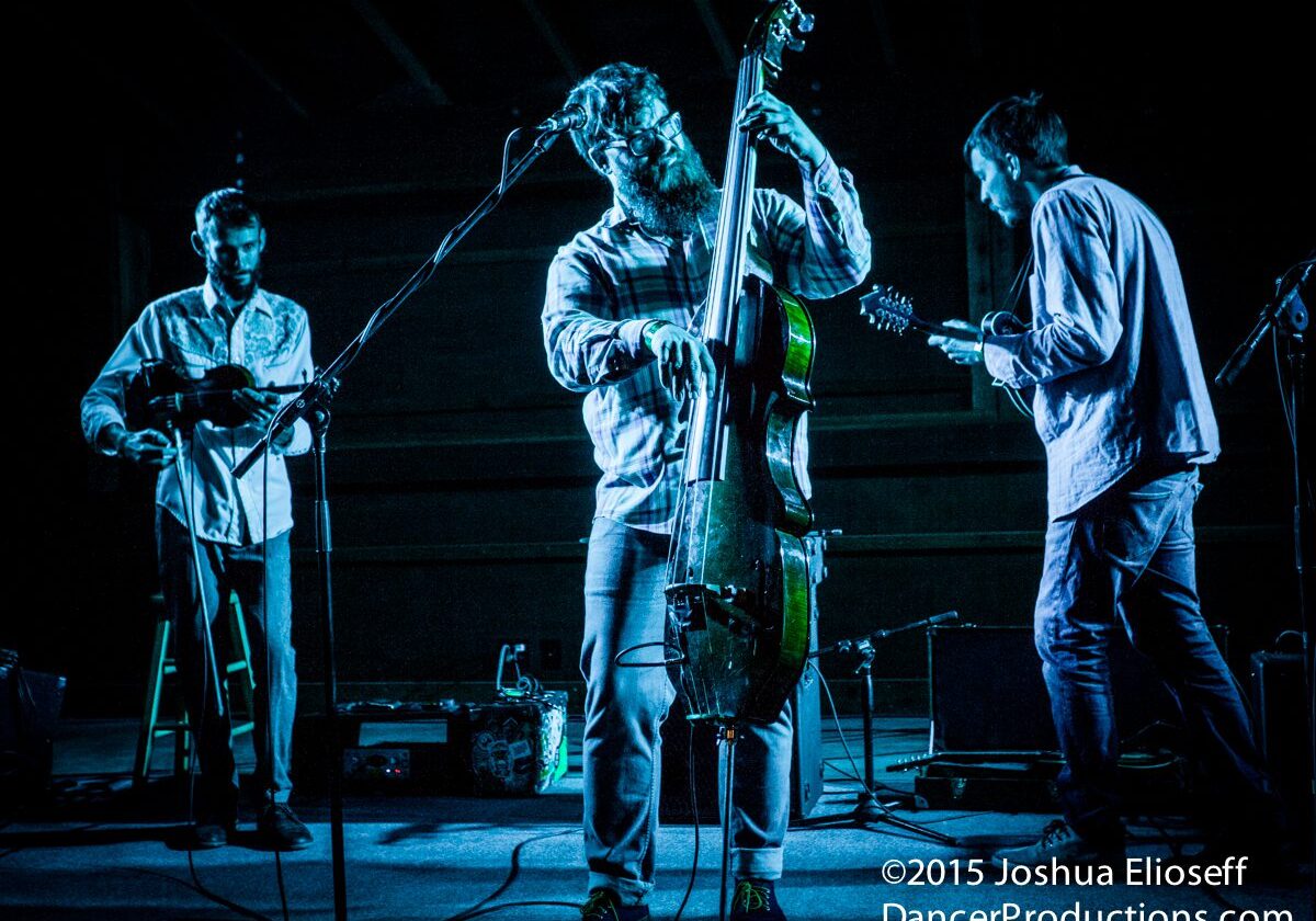 Musicians performing on stage with instruments.