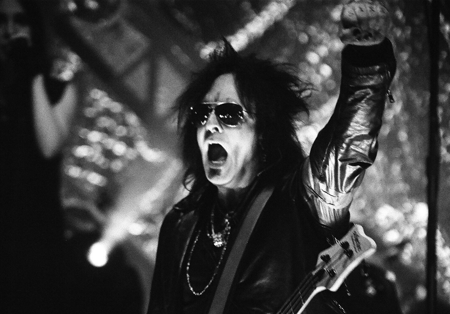 Rock musician performing energetically on stage.