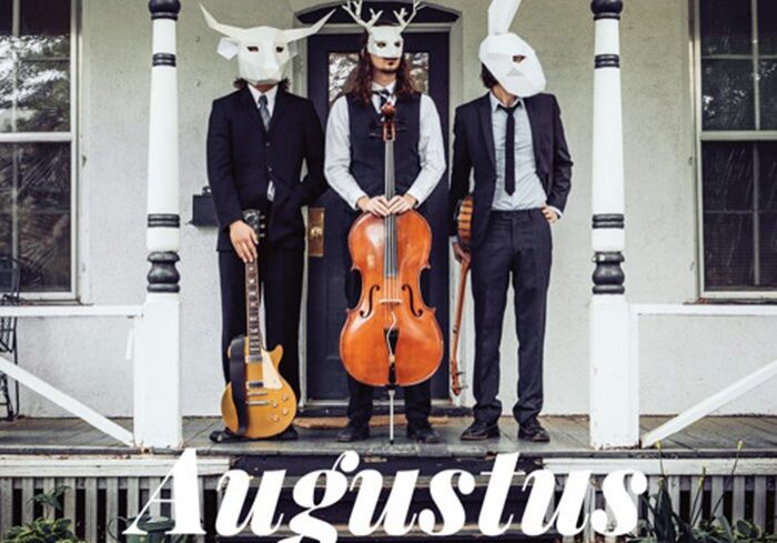 Three musicians in animal masks with instruments.