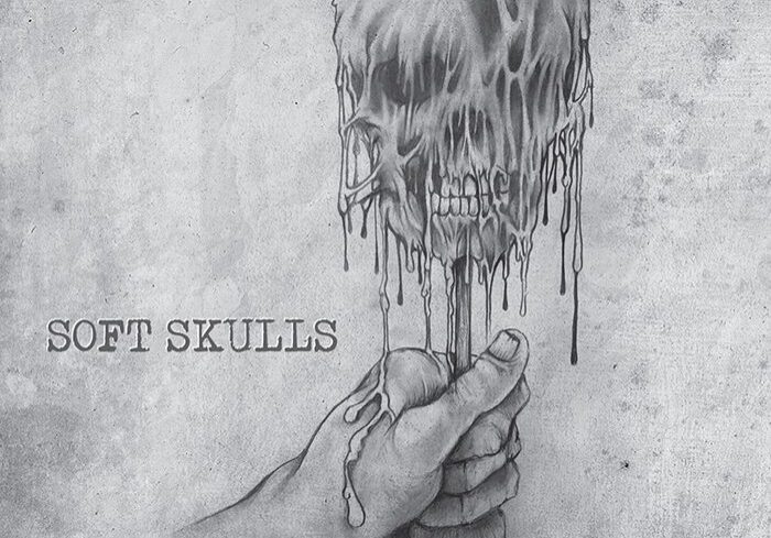 Hand holding melting skull illustration.