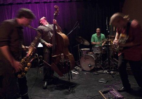 Jazz band performing energetically on stage.