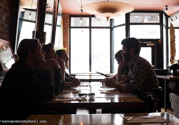 People dining in a dimly lit restaurant.