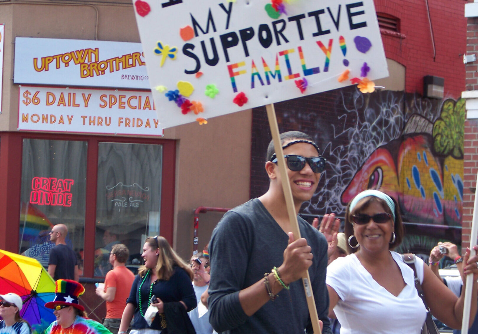 Person holding "I love my supportive family" sign.