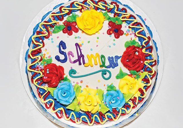 Colorful cake with decorative icing flowers.