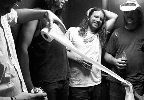 Group of men with toilet paper roll.