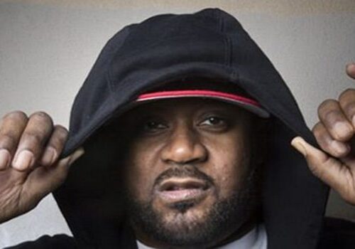 Person wearing a black hoodie and cap.