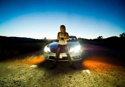 Person standing in front of a car.