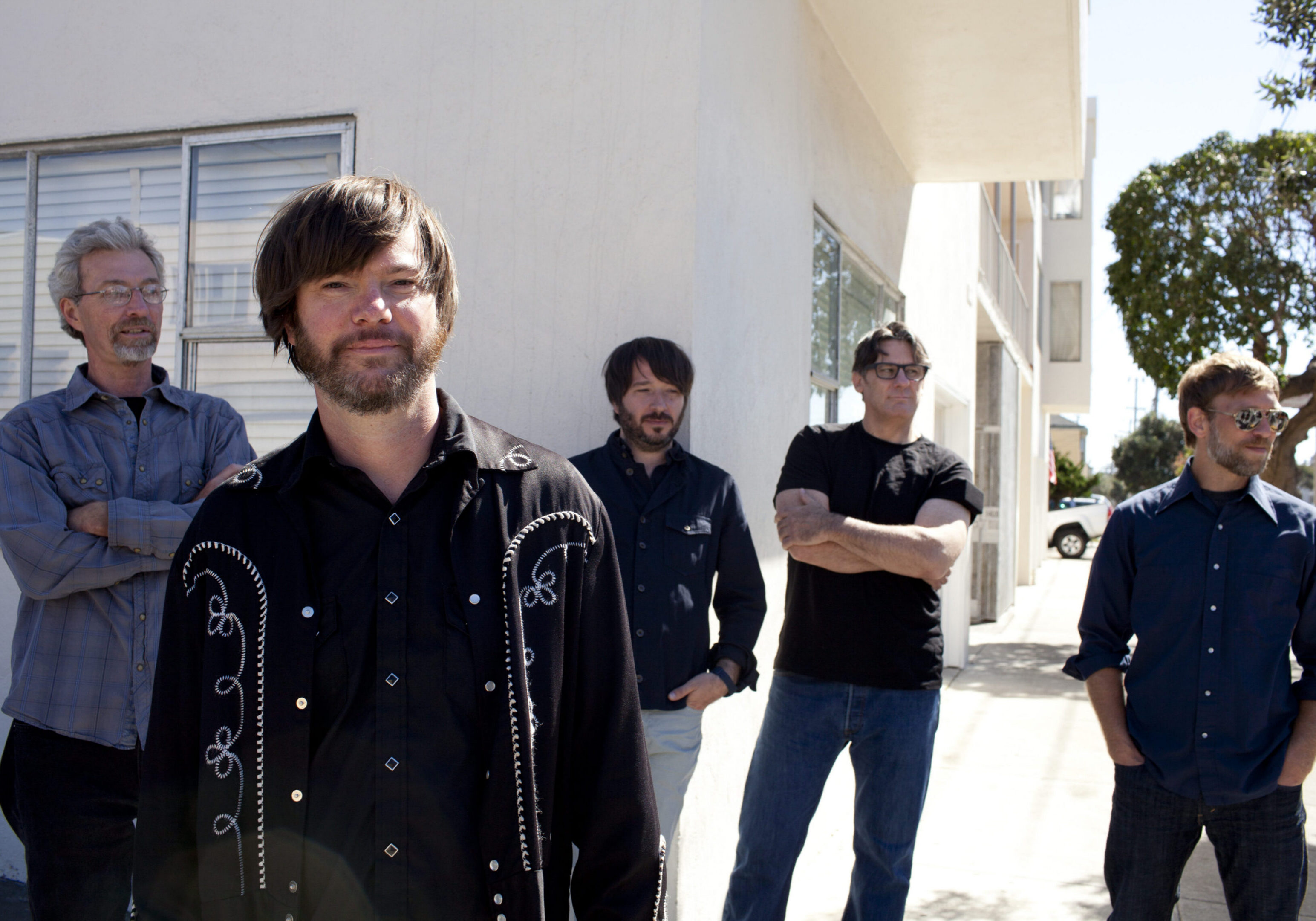 Five men standing outside a building.