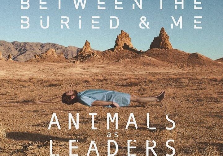 Person lying in desert, band names visible.