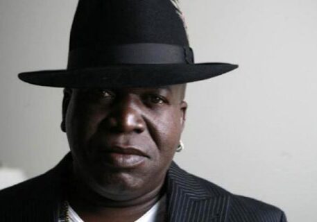 Man wearing a black hat and jacket.
