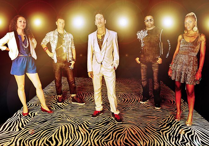 Group posing on zebra-patterned floor.