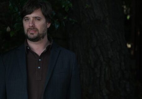 Man standing in front of a tree.