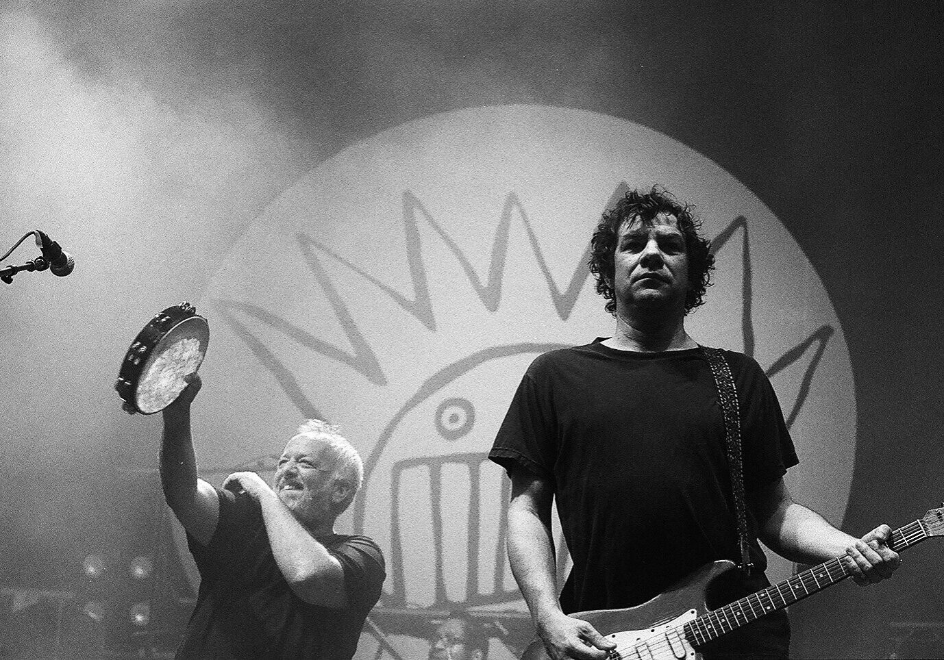 Musicians performing on stage with instruments.