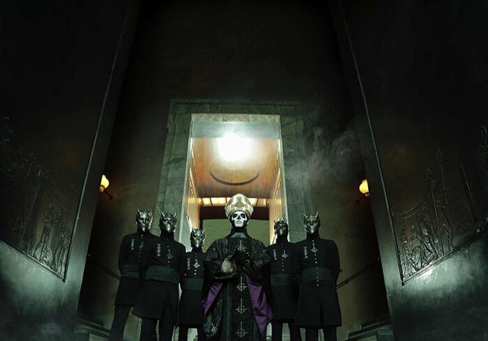 Band in theatrical costumes on stairs.