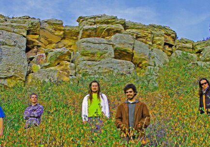 People standing in a colorful rocky landscape.