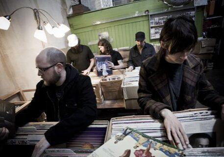 People browsing vinyl records in a store.