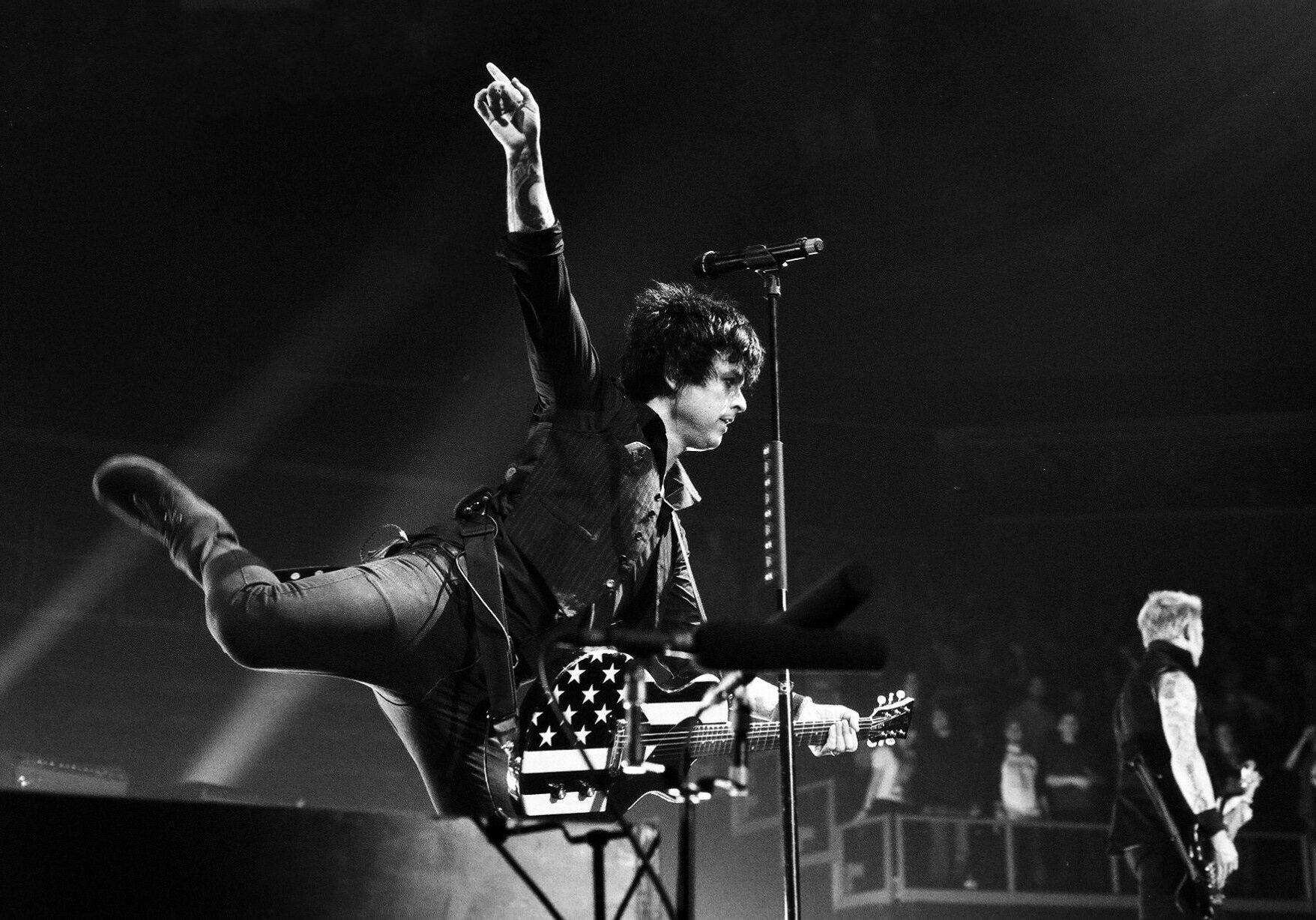 Guitarist performing energetically on stage.