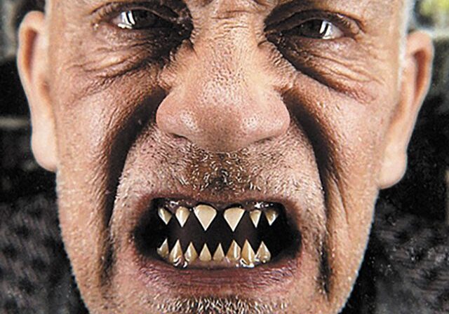 Man with sharp teeth and intense expression.