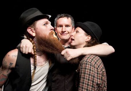 Three people posing with long beard.