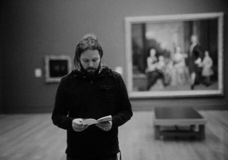 Person reading in an art gallery.