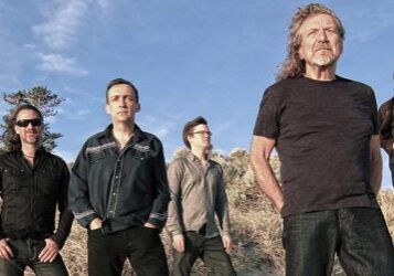 Seven people standing in a desert landscape.