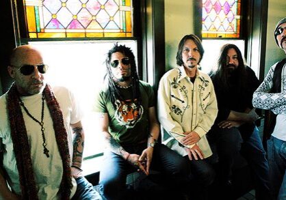 Five men sitting in front of windows.