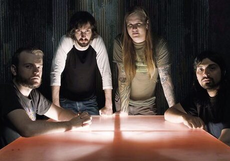 Band members gathered around a glowing table.