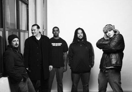 Five men posing in black and white.