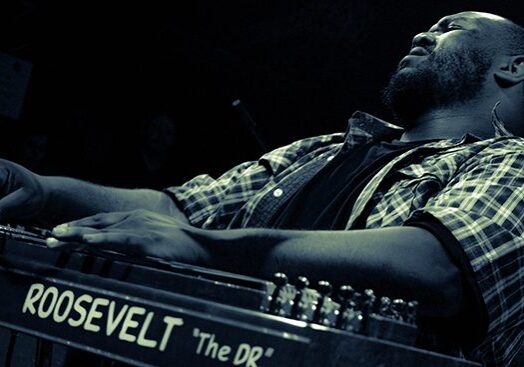 Musician passionately playing a keyboard instrument.