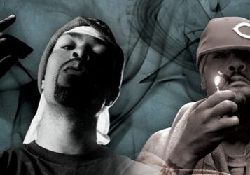 Two men with hats and smoke background.