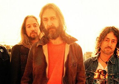 Five men standing in warm sunlight.