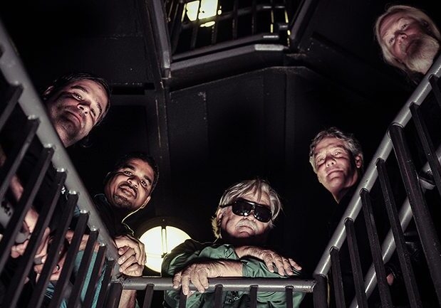 Five people looking up from staircase.