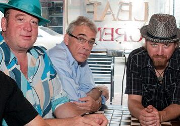 Five men sitting together at a table.