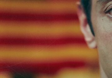 Half face with blurred striped background.
