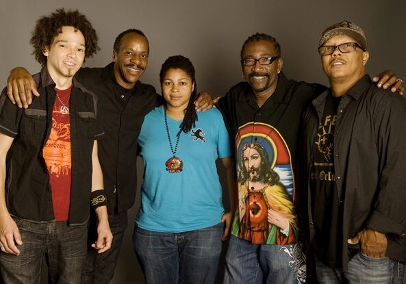 Group of five people posing together.